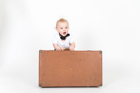 Little boy with the suitcase on the white backgroundの写真素材
