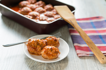 Portion of three meatballs on white plateの写真素材