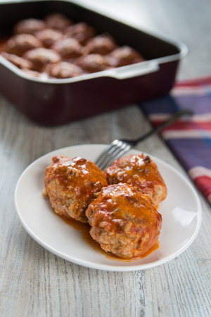 Portion of three meatballs on white plateの写真素材