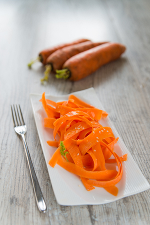 Vitamin carrot salad on the white plateの写真素材
