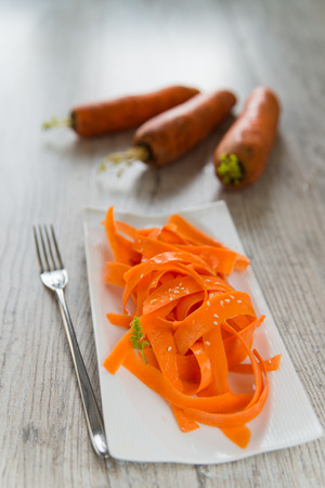 Vitamin carrot salad on the white plateの写真素材