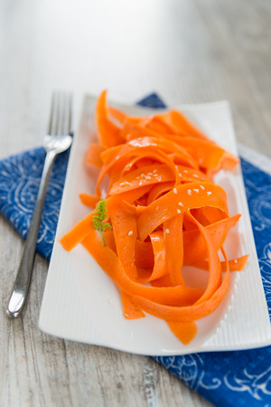 Vitamin carrot salad on the white plateの写真素材