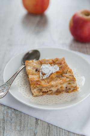 Piece of an apple pie and two applesの写真素材