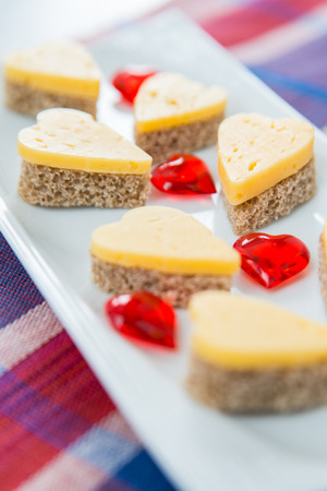 Heart shaped cheese sandwiches on the white plateの写真素材