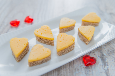 Heart shaped cheese sandwiches on the white plateの写真素材