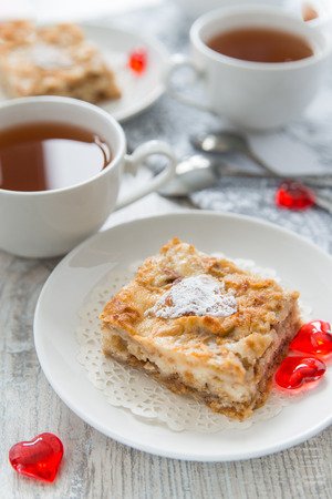 Piece of an apple pie with teaの写真素材