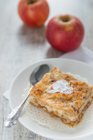 Piece of an apple pie and two applesの写真素材