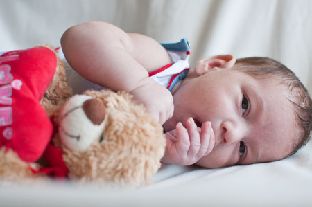 Portrait of Little baby with the toy bearの写真素材