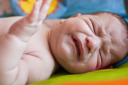 The horizontal portrait of the crying little babyの写真素材