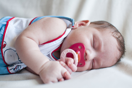 Portrait of the sleeping baby with red nippleの写真素材