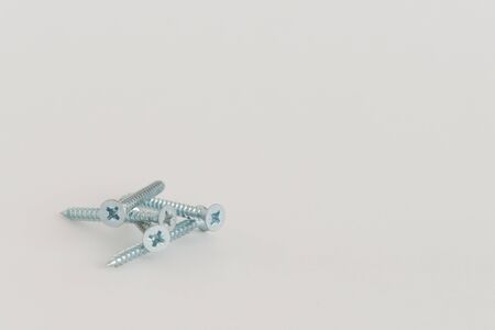 Five steel metal screw on the white background with the copyspaceの写真素材