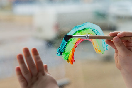 let's all be well. child at home draws a rainbow on the window. Flash mob  chasetherainbow on...