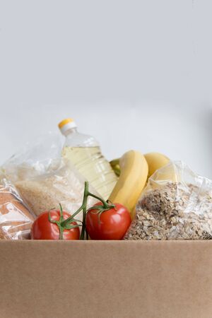 Various food in the carton box   with copy space. Donation food in the box. Fruits, oil and cerealsの写真素材