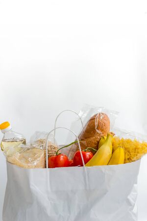 Various food in the paper bag  with copy space. Donation food in the white bagの写真素材