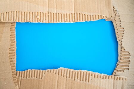 Frame made of torned corrugated brown cardboard with copy space. No waste and recycling conceptの写真素材