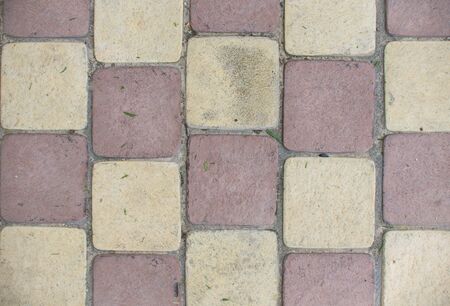 Top view of the red and yellow pavement background. Full frame of regular square cobbles in lines.の写真素材