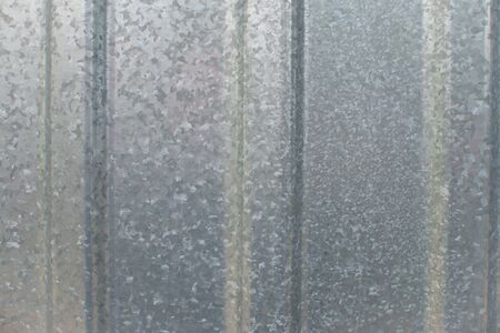 Corrugated galvanized iron plate texture. metal fence surface background closeupの写真素材