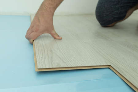 Flooring renovation. Setting of the laminate floor. Repair conceptionの写真素材