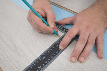 Floor renovation. Measuring and checking before setting of the laminate floorの写真素材