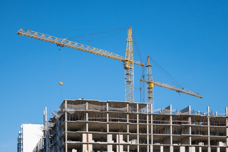 Construction cranes on the background of the sky. Building the skyscraper.の写真素材