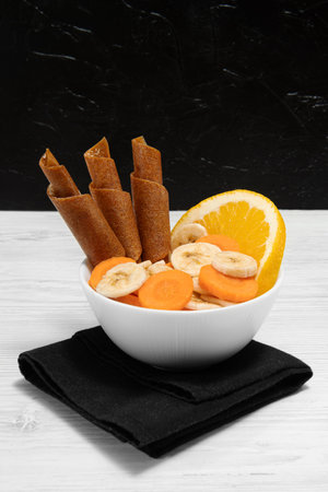 Fruit peel fruit in rolls. Pastille. Background for text and articles about eating healthy....