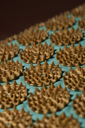 Orthopedic green mat with sharp golden spikes. Alternative therapy and relaxation tool.の写真素材