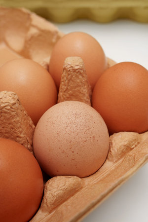 Farm eggs in a beige paper box. Close-up.