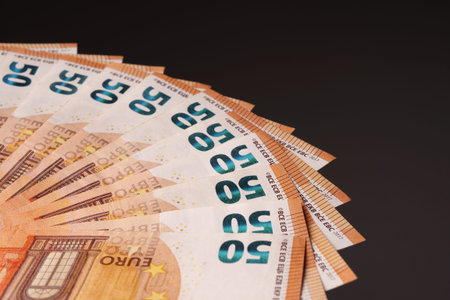 50 euro bills on a black background, arranged in a fan. Studio shooting.