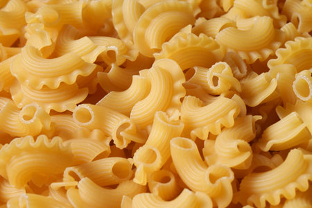 Dried scalloped pasta. The texture of pasty noodles, the background of noodles.