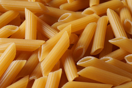 Raw organic penne pasta, top view. Lots of pasta.の写真素材