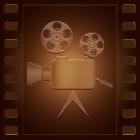 Movie camera of an obsolete design located on a film of brown colorの写真素材