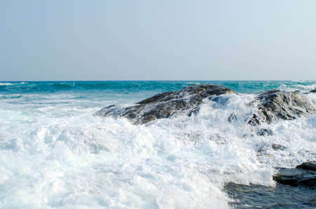 The sea wave is crashed about the shore and rocksの写真素材