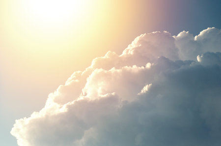 Beautiful sky with clouds, due to which the sun and rays are visible.