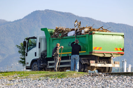 Batumi, Ceorgia, November 04, 2017: Garbage collecting with the help of people in a special car on the street.のeditorial素材