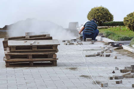 Working laying of paving slabs.の写真素材