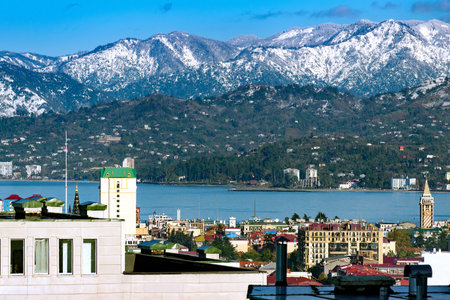 Picturesque view of the city, the roofs of the houses, the sea, the mountains covered with snow. Close up to nature.の写真素材