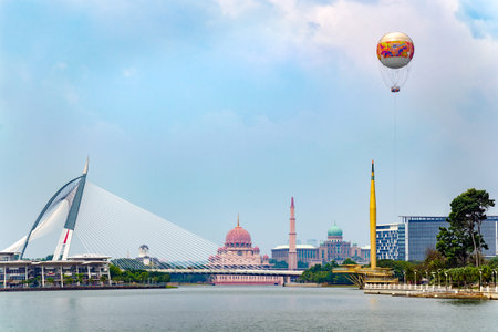 Cyberjaya, Selangor, Malaysia, 02/23/2018: Beautiful city view with lake, Putra Mosque Masjid , bridge, Millennium Monument Alaf Baru, with air balloon from Skyrides Festivals Park Putrajaya.のeditorial素材