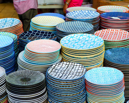 Kuala Lumpur - street market, stacks of plates with beautiful bright design, tracery.の写真素材
