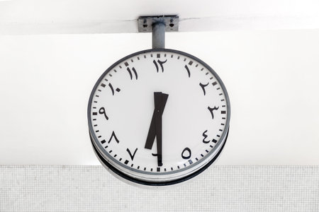 Modern clock round shape with Arabic circulars on dial and hands, showing the time 6: 30.の写真素材