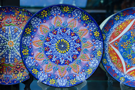 Beautiful blue plate with traditional Turkish flower pattern, colorful painting on the dishes. Souvenir shop.の写真素材