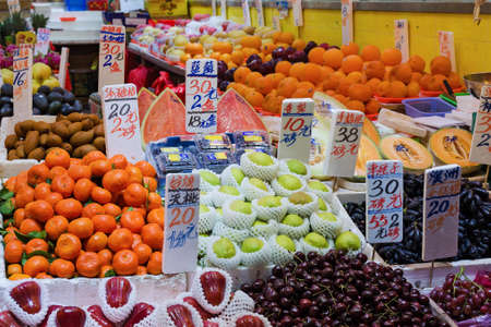 Hong Kong, China, 2018-03-06: Fruit market - boxes with fruits on the street, with price tags, wide range of wholesome food. Agricultural concept.のeditorial素材