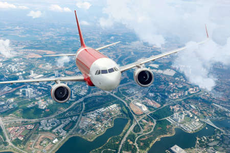 Plane flying sky. Airplane above city. Passenger aircraft climbs through the clouds. Planes and cities.のeditorial素材
