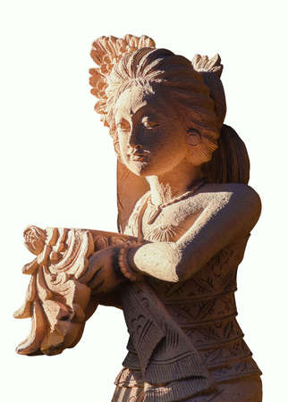 Traditional Balinese sandstone woman statue, welcome offering in her hands. Iconic Bali. Isolated on white background.の写真素材