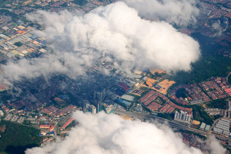 Aerial view of the modern city in Malaysia with houses, streets. Vew from an airplane thru the clouds.の写真素材