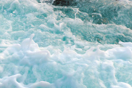 Dense sea foam on the water surface, view from above. Photo with motion blur.の写真素材