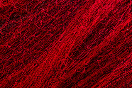 Background with red fishing netting. Old marine net texture.の写真素材