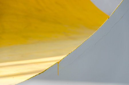 Colorful (yellow, gray, white) painted wall with cracks. Abstract colorful background with texture,...