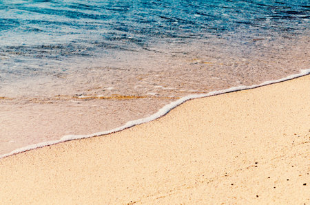 Sandy ocean beach, soft focus. Tropical photo background. Seascape abstract. Sandy beach wave.