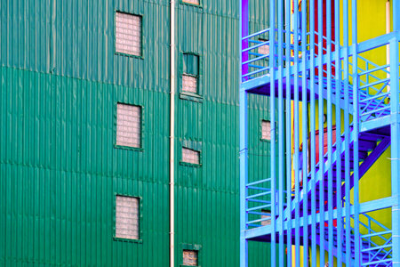 Facade green wall of a residential building with texture and a staircase. Architectural forms of the...