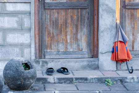  Doorstep of a poor house with a wooden door. View from the bottom angle.の写真素材